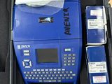 a blue case with a keyboard and a box with papers in it