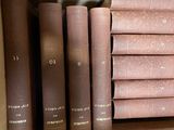 several books are stacked on top of each other in a box