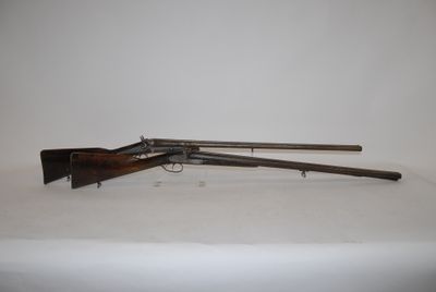 an old gun with a wooden handle and a wooden barrel