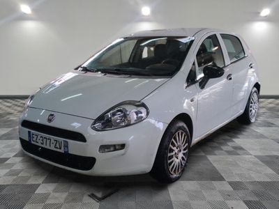 a picture of a small white car on a checkered floor