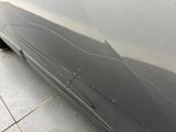 a close up of a car ' s front bumper with a crack in it