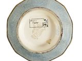 a blue and white plate with a bird on it