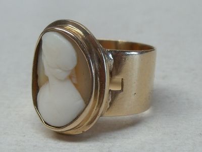 a gold ring with a white stone in it