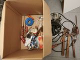 a cardboard box filled with tools on the floor