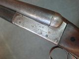 a close up of a gun with a metal handle on a table