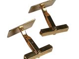 pair of gold tone cufflinks on white background with clippings