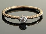 an image of a diamond ring on a reflective surface