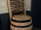 a wooden barrel that has a ladder on top of it