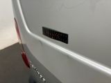 a close up of a white van with a sticker on it