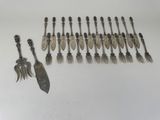 several spoons and forks are lined up on a white surface