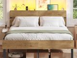 a bed that has a wooden headboard on top of it