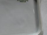 a white tray with a green and white design on it
