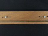 an image of a close up of a wooden shelf on a black background