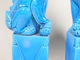 pair of blue foo foo foo statues sitting on top of a blue box