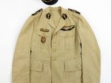 an old military uniform with a hat on top of it