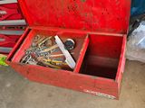 a red tool box with tools in it in a garage