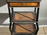 an old wooden table with three shelves on top of it