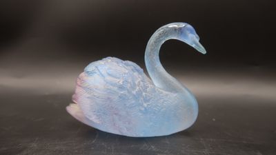 a glass swan that is sitting on a table