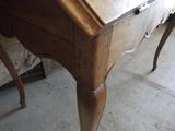 a wooden desk with a drawer on top of it
