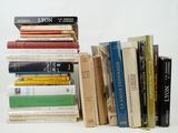 many books stacked on top of each other on a table