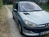 a silver car that is parked on the side of the road