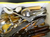 une boîte remplie d'argenterie et d'autres ustensiles de cuisine