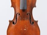 an old violin sitting on top of a white surface