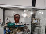 a glass display case with a lot of vases on it