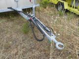 a trailer with a trailer attached to it in the grass