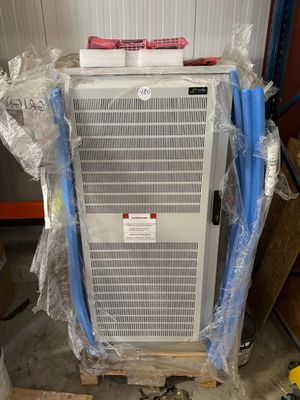 a air conditioner sitting on a pallet in the middle of a room