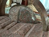 a bed with a stone headboard and a mirror