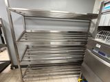 a stainless steel shelf in the middle of a kitchen