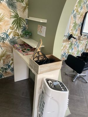 a room with a desk, chair, and air conditioner in it
