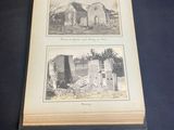two open books sitting on a table with pictures of buildings on them