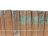 a stack of books sitting on top of a wooden fence