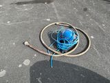 an image of a blue ball and a hose laying on the ground