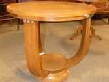 a wooden table with a wooden base in a room