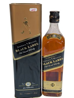 a bottle of black label whisky next to a cardboard box