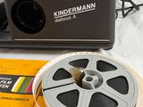 a camera and a film reel sitting on top of a table