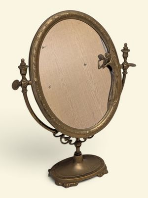 une image représentant un miroir posé sur un pied, sur lequel se trouve un oiseau