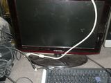 a computer monitor and keyboard sitting on a desk