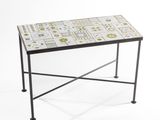 a small table with a tiled top and metal legs