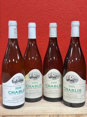 six bottles of wine are lined up on a wooden table
