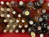 many bottles of beer in a red basket on the table
