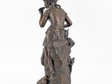 an image of a bronze statue of a woman holding a bird