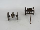 two small toy guns sitting next to each other on a white surface