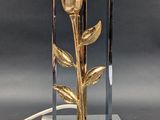 a lamp that has a gold flower on it