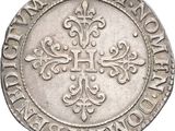 a close up of a coin with a cross on it