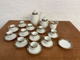 many cups and saucers sitting on a table