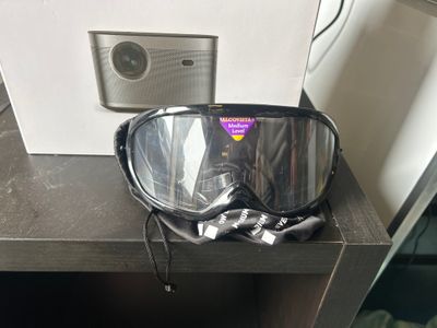 a pair of goggles sitting on a table next to a camera